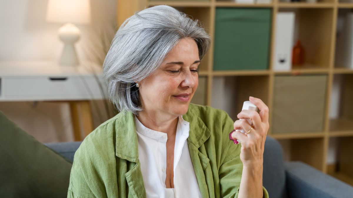 Woman with fatty liver holding an inhaler medication