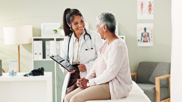 A woman talking to her new doctor in a medical office