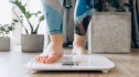 Close-up of a woman stepping on a scale after reversing her fatty liver disease