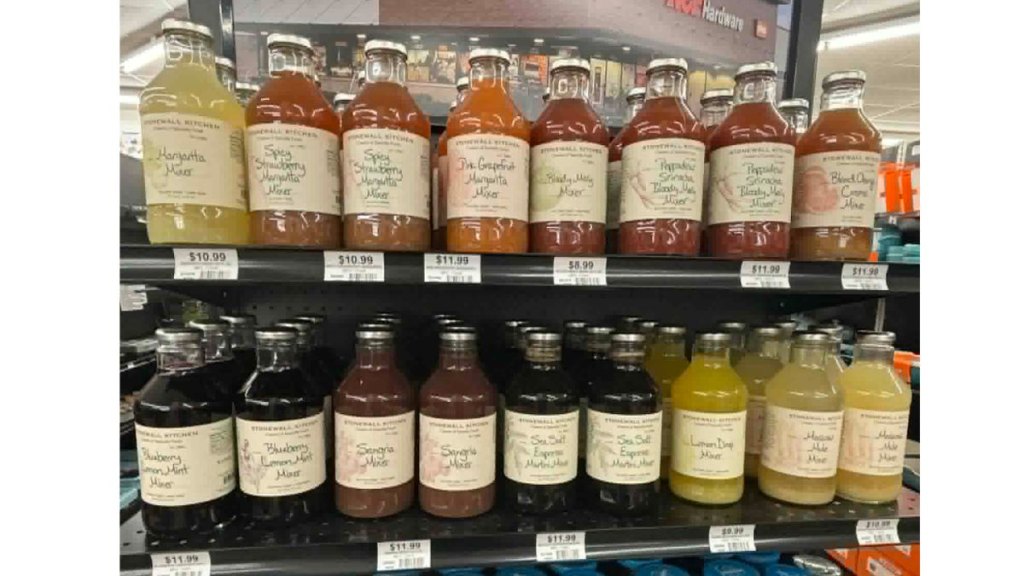 Shelves of vcolorful cocktail mixer jugs at Ace Hardware.
