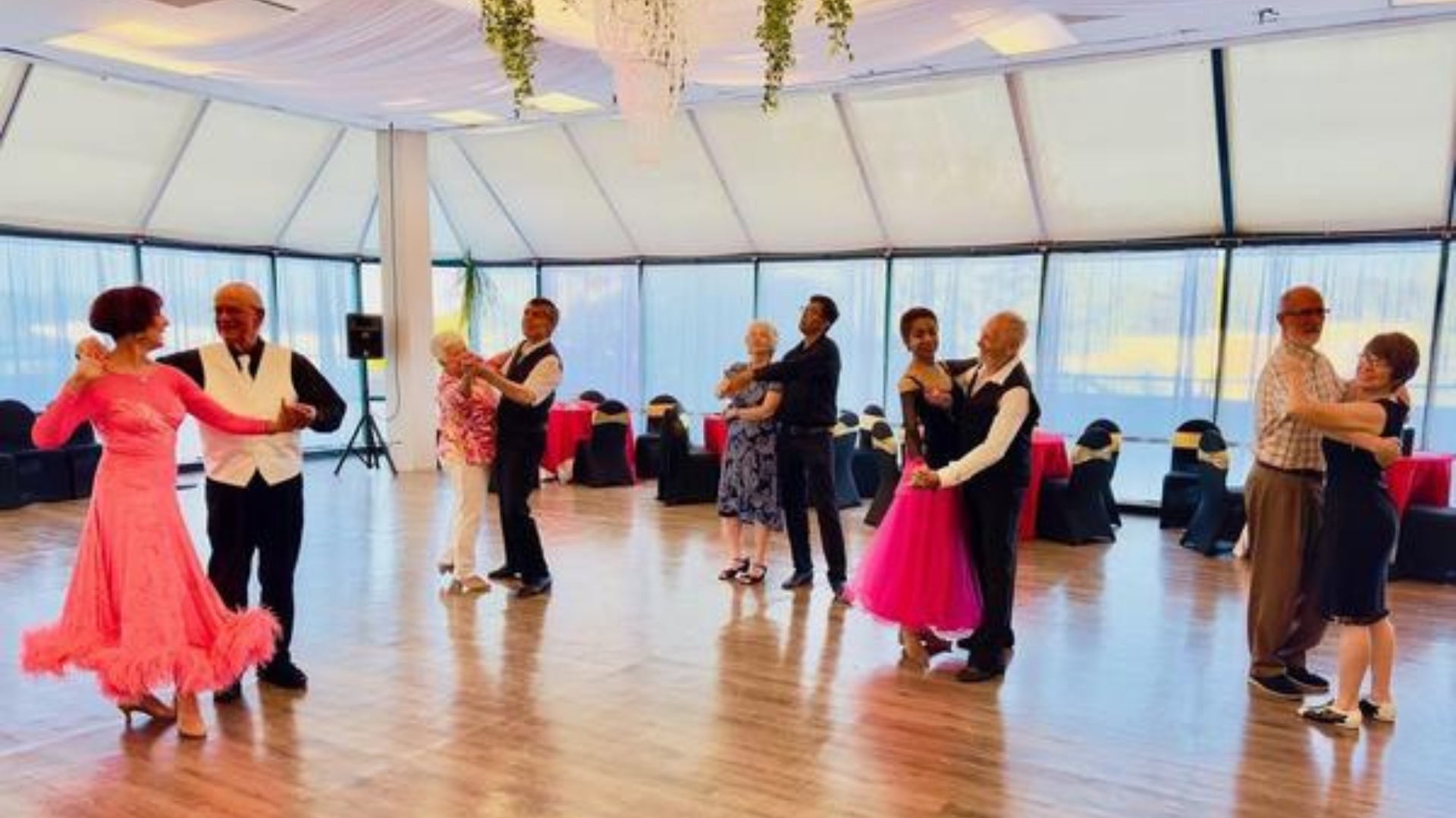 Group practicing ballroom dancing at A Step to Gold studio
