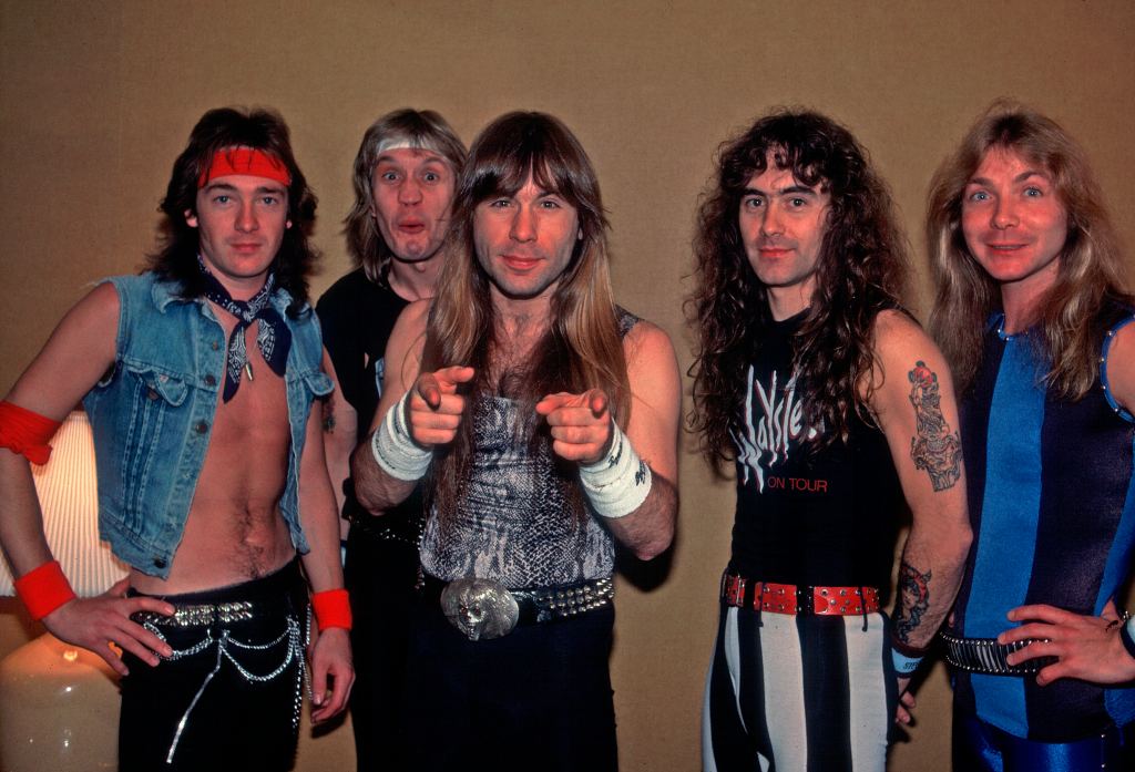 Portrait of British heavy metal band Iron Maiden backstage at the Poplar Creek Music Theater in Hoffman Estates during their World Slavery Tour, Chicago, Illinois, June 16, 1985. Pictured are Adrian Smith, Nicko McBrain, Bruce Dickinson, Steve Harris, and Dave Murray. 