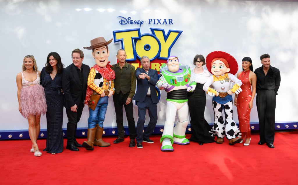 LONDON, ENGLAND - MAY 28: (L-R) Sian Welby, Lindsey Collins, Andrew Stanton, 'Woody', Tom Hanks, Tim Allen, 'Buzz Lightyear', Joan Cusack, 'Jessie', Greta Lee and Jordan North attend the "Toy Story 5" UK launch event at Odeon Luxe Leicester Square on May 28, 2026 in London, England. (Photo by Karwai Tang/WireImage)