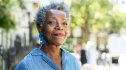 A woman with alzheimer’s disease symptoms smiling outdoors