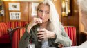 woman sipping diet soda at a restaurant