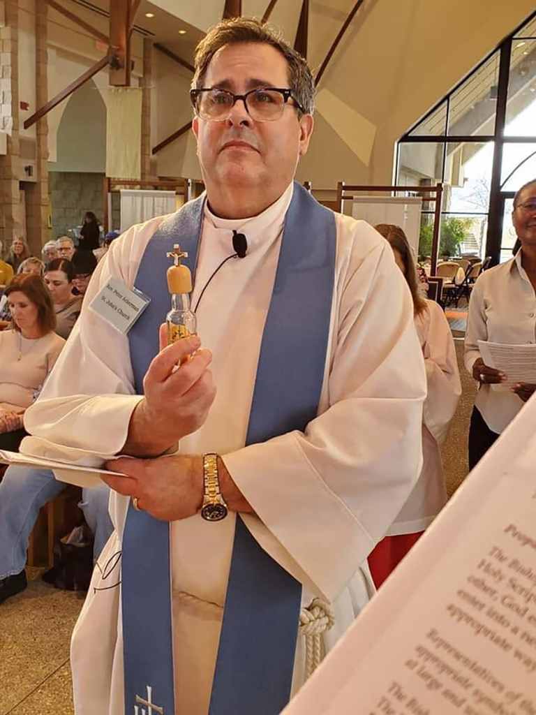 Father Peter K. Ackerman on the day he was installed in the church by Bishop David Rice.