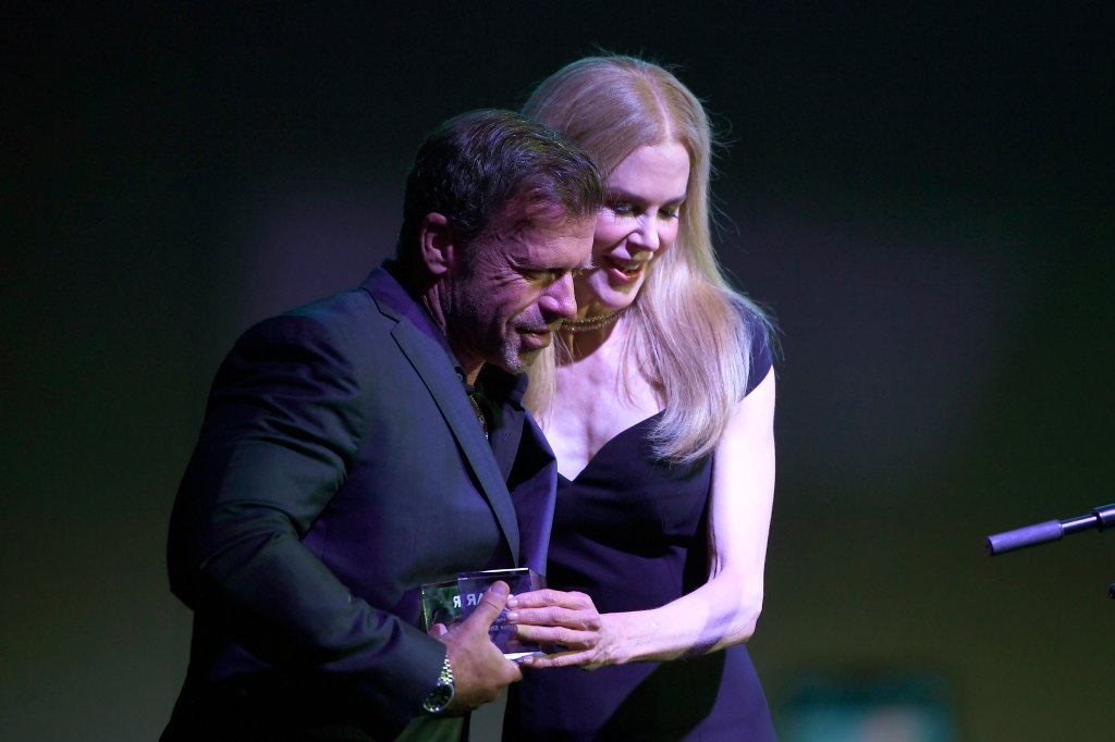 DALLAS, TEXAS - OCTOBER 04: (L-R) Taylor Sheridan and Nicole Kidman speak onstage during the amfAR Dallas Gala at a Private Residence on October 04, 2025 in Dallas, Texas. (Photo by Ryan Emberley/amfAR/Getty Images for amfAR)
