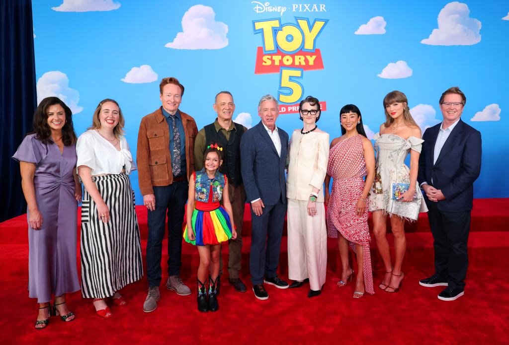 LOS ANGELES, CALIFORNIA - JUNE 09: (EDITORIAL USE ONLY. NO STANDALONE PUBLICATION USE. NO SPECIAL INTEREST OR SINGLE ARTIST PUBLICATION USE; NO BOOK USE) (L-R) Lindsey Collins, Kenna Harris, Conan O'Brien, Scarlett Spears, Tom Hanks, Tim Allen, Joan Cusack, Greta Lee, Taylor Swift and Andrew Stanton attend the Toy Story 5 Los Angeles World Premiere at Dolby Theatre in Los Angeles, California on June 09, 2026. (Photo by Kevin Mazur/Getty Images for for TAS Rights Management)