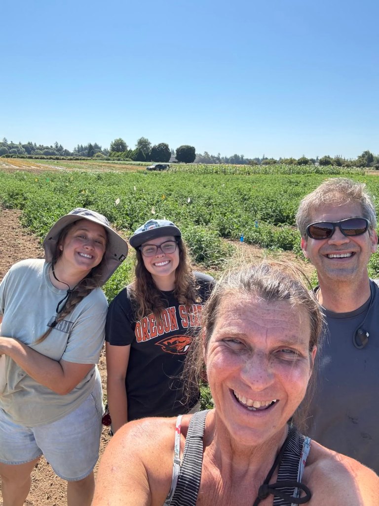 Jean-Marie and Cory receive help from volunteers to harvest blueberries and other produce