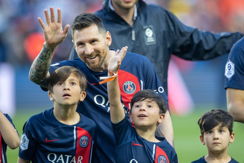 PARIS, FRANCE - JUNE 3: Lionel Messi #30 of Paris Saint-Germain with his sons Thiago, Mateo, and Ciro, as they look to spot his wife and the boy's mother Antonela Roccuzzo in the crowd after the players were accompanied by their children for pre-match presentations before the Paris Saint-Germain V Clermont, French Ligue 1 regular season match at Parc des Princes on June 3, 2023, in Paris, France (Photo by Tim Clayton/Corbis via Getty Images)