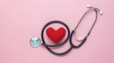 A heart and stethoscope against a pink background