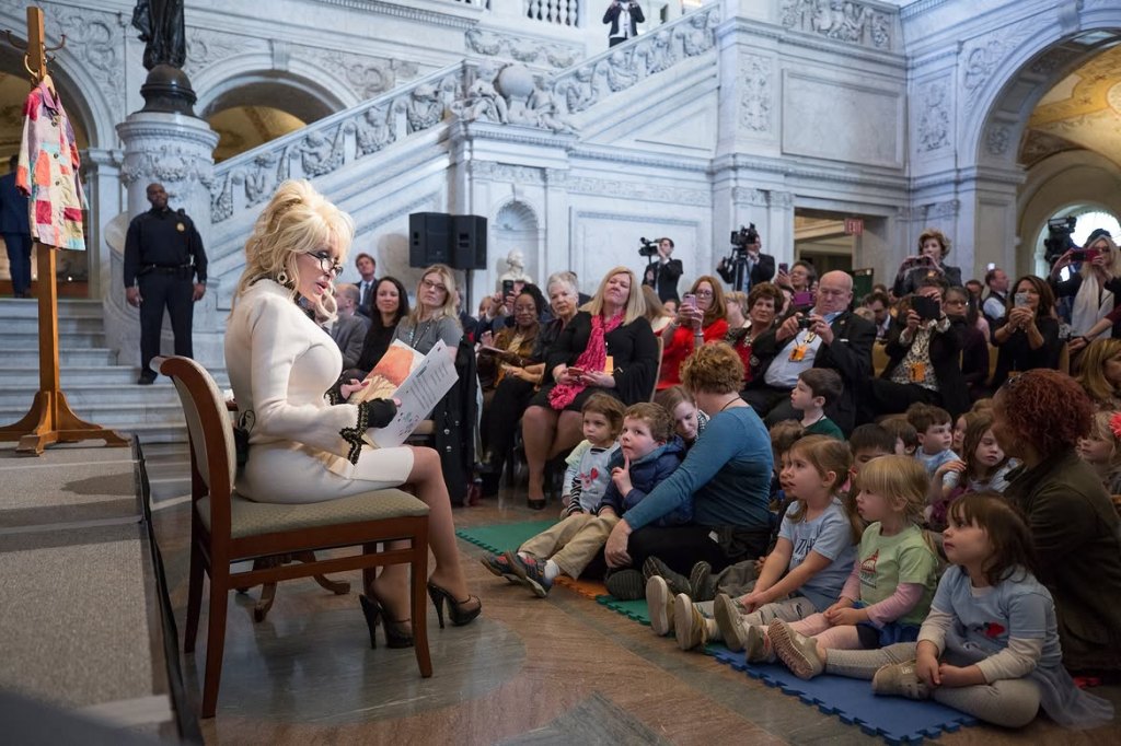 Dolly Parton reads "Coat of Many Colors," the one hundred millionth book donated by Parton's nonprofit Imagination Library, during a ceremony in the Great Hall