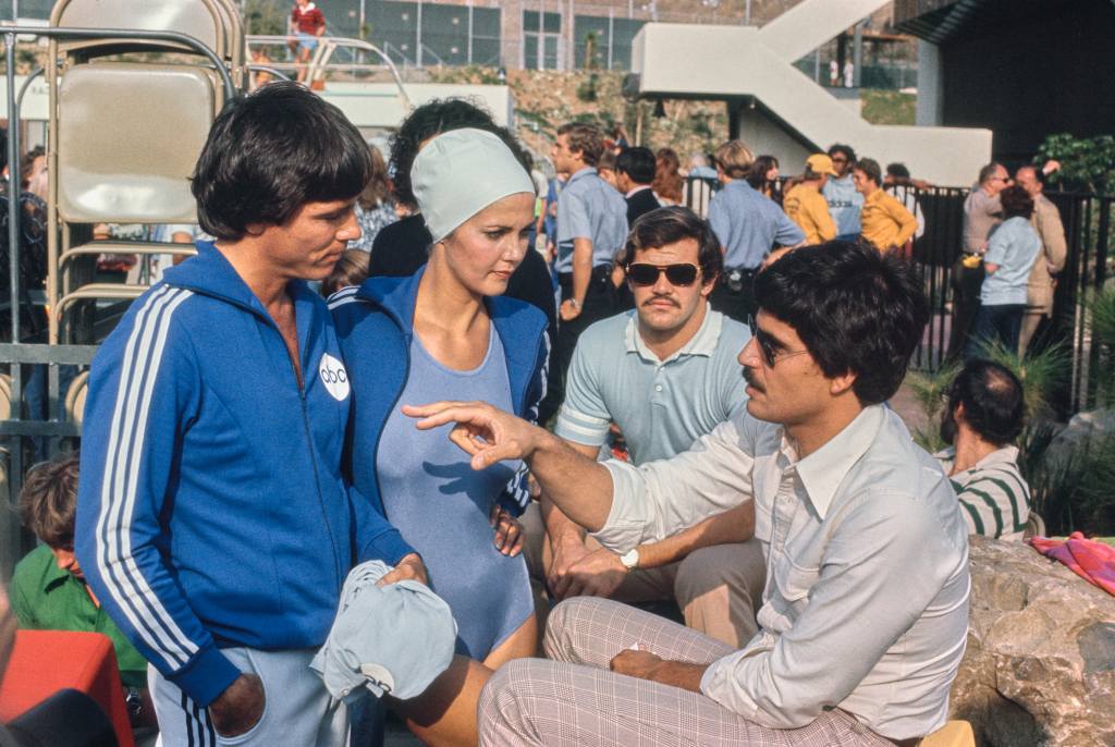 American swimmer Mark Spitz in conversation with Lynda Carter in February 1977.