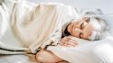 A woman peacefully sleeping in bed after exercising