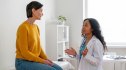 A woman talking to her pelvic floor specialist in a doctor's office