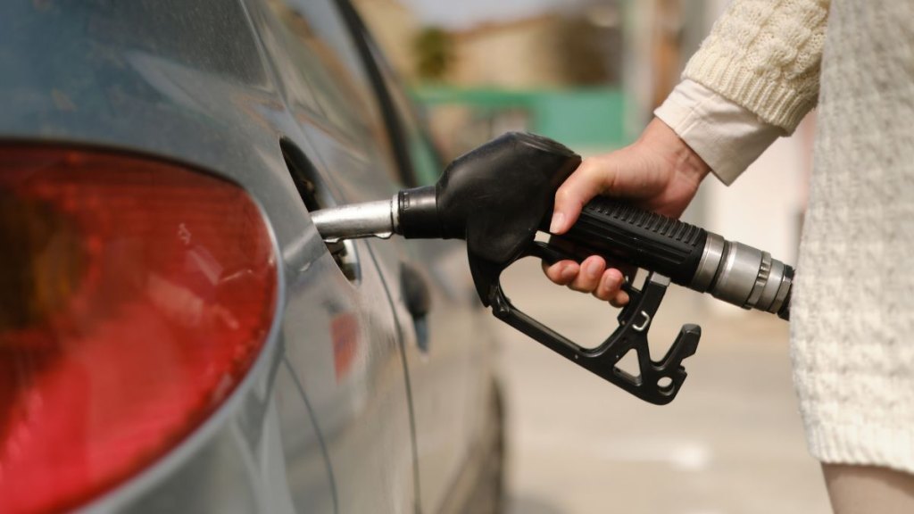 woman using gas pump
