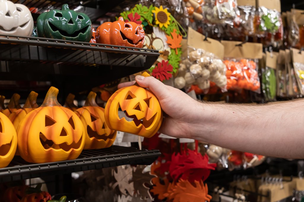 Shopper picking out Halloween decorations in a store