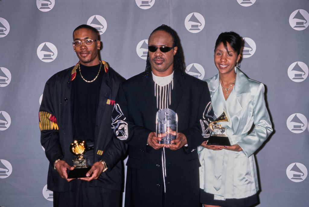 Stevie Wonder with son Keita Morris (L) and daughter Aisha Morris (R) holding Wonder's awards at the 38th Grammy Awards, Shrine Auditorium, Los Angeles, February 28th 1996