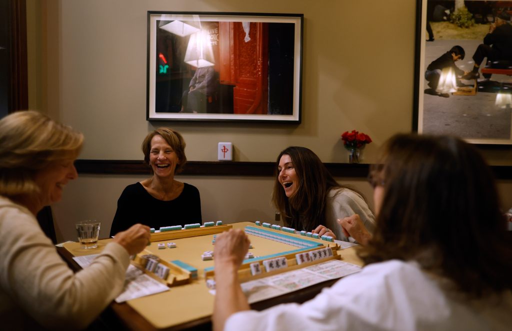 A group of women gather to play Mahjong