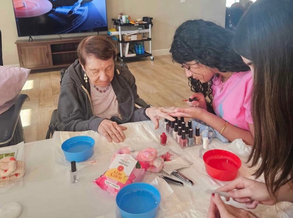 Teens painted nails during one fun visit at an assisted living community