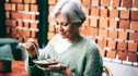 A woman eating granola with berries, one of the best foods for Alzheimer's disease prevention
