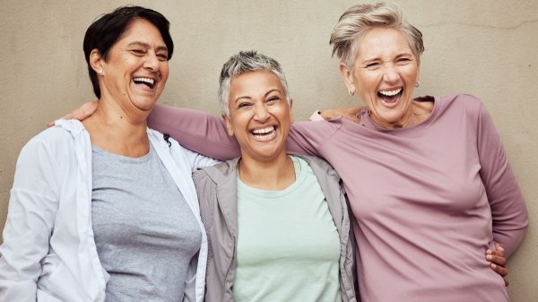 Three woman laughing and socializing to help boost their memory