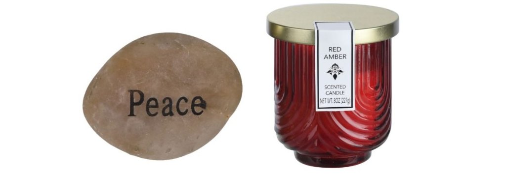 Dollar Tree river stone printed with "peace" and amber candle