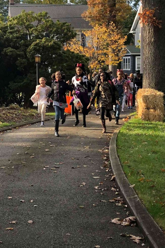 The kiddos run to the Book Lady's house on Halloween