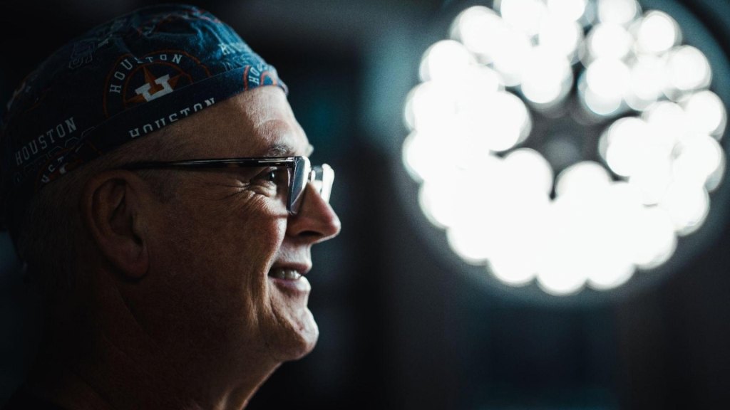 Dr. Leo Lapuerta, Houston plastic surgeon in front of a medical light