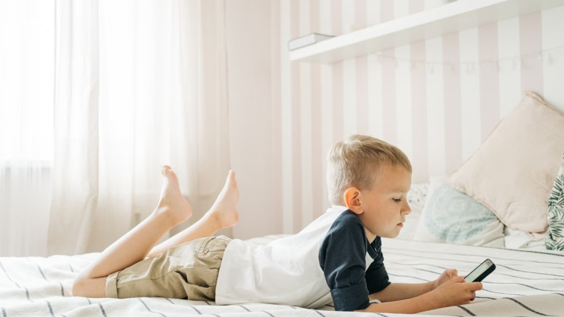 Child watching a screen while sitting at home