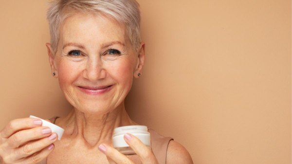 Close-up image of woman holding skincare cream that works like a Botox alternative