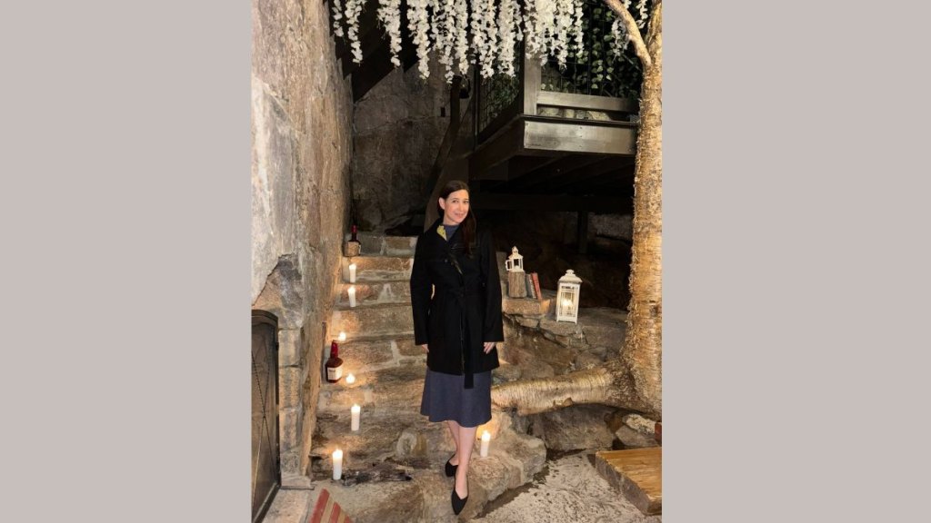 A woman stands in the interior of the Maker's Mark Hobbit House at The Preserve
