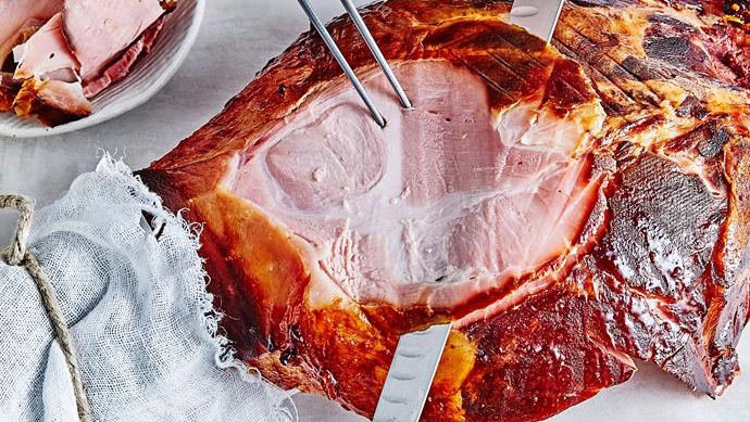 cutting ham slices along the bone