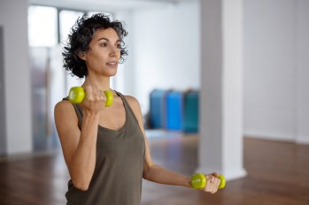 Woman using light weights to strengthen arms
